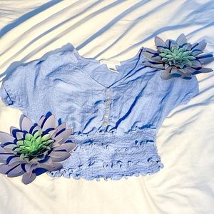 Blue top with a deep v and white buttons